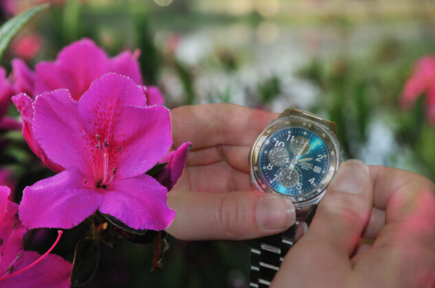 Watch next to flower